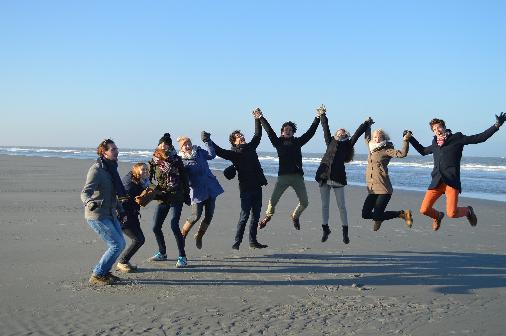 group jump on the beach