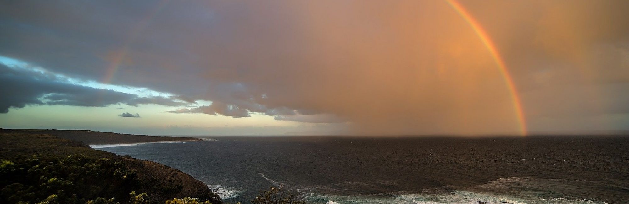 rainbow over stormy seas
