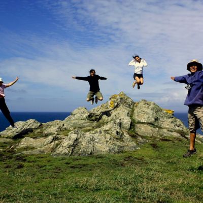 Family jumping at Land's End